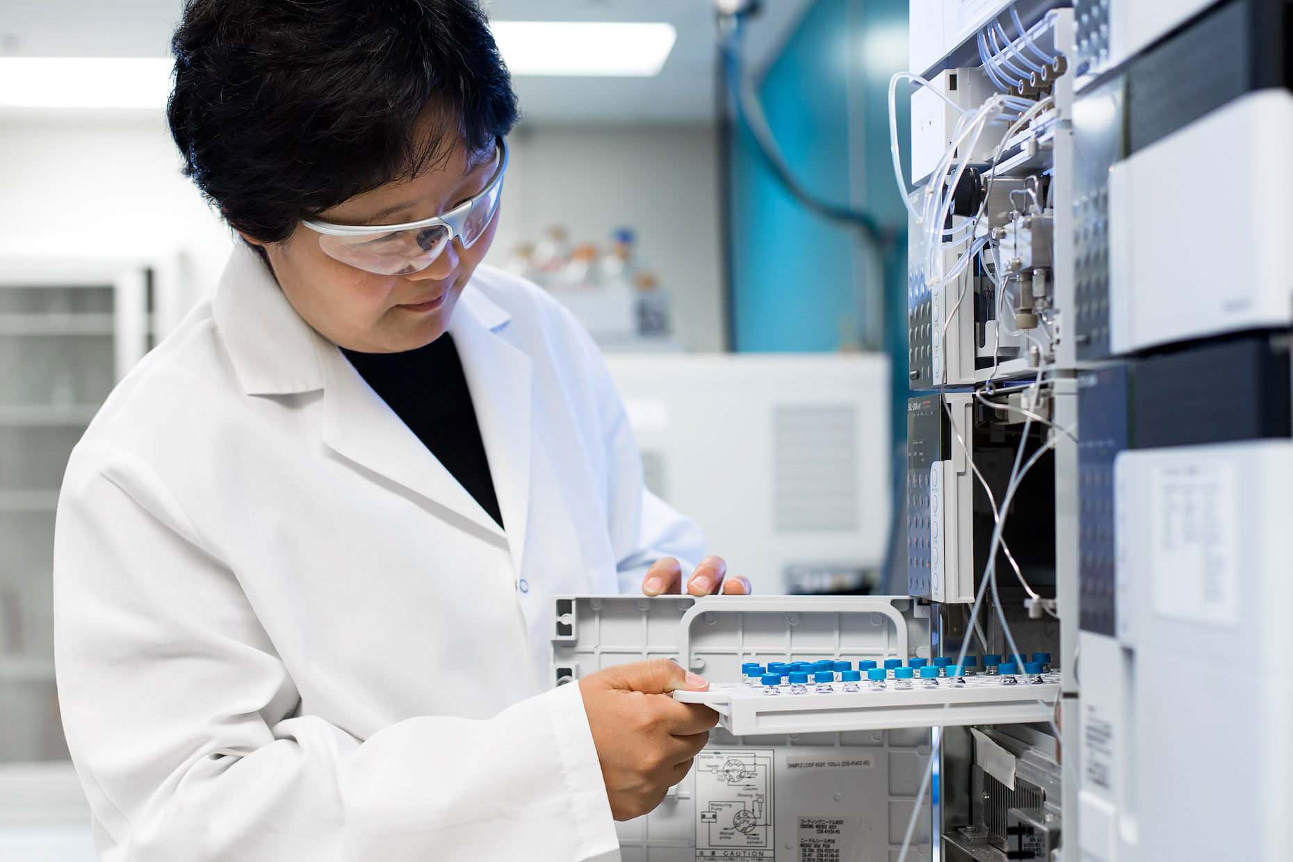 Biochemist removing samples from a protein sequencer | Scott Gable industrial photographer