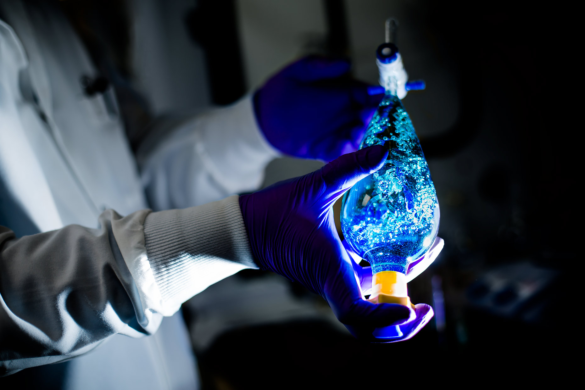 The gloved hands of a technician agitating liquid | Scott Gable industrial photographer
