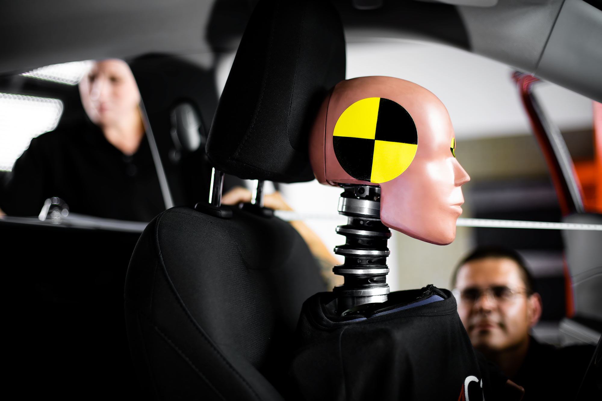 Profile of a crash test dummy with technicians in background |  Scott Gable industrial photographer