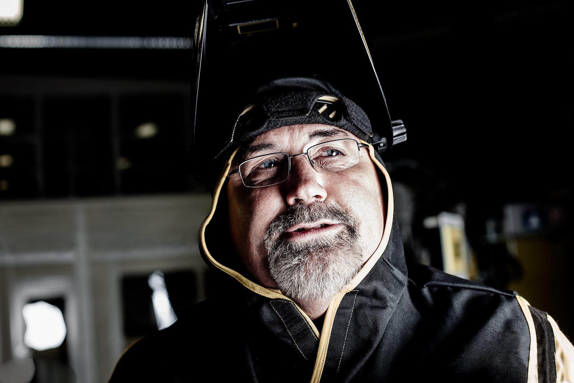 Portrait of a welder with safety mask up |  Scott Gable industrial photographer
