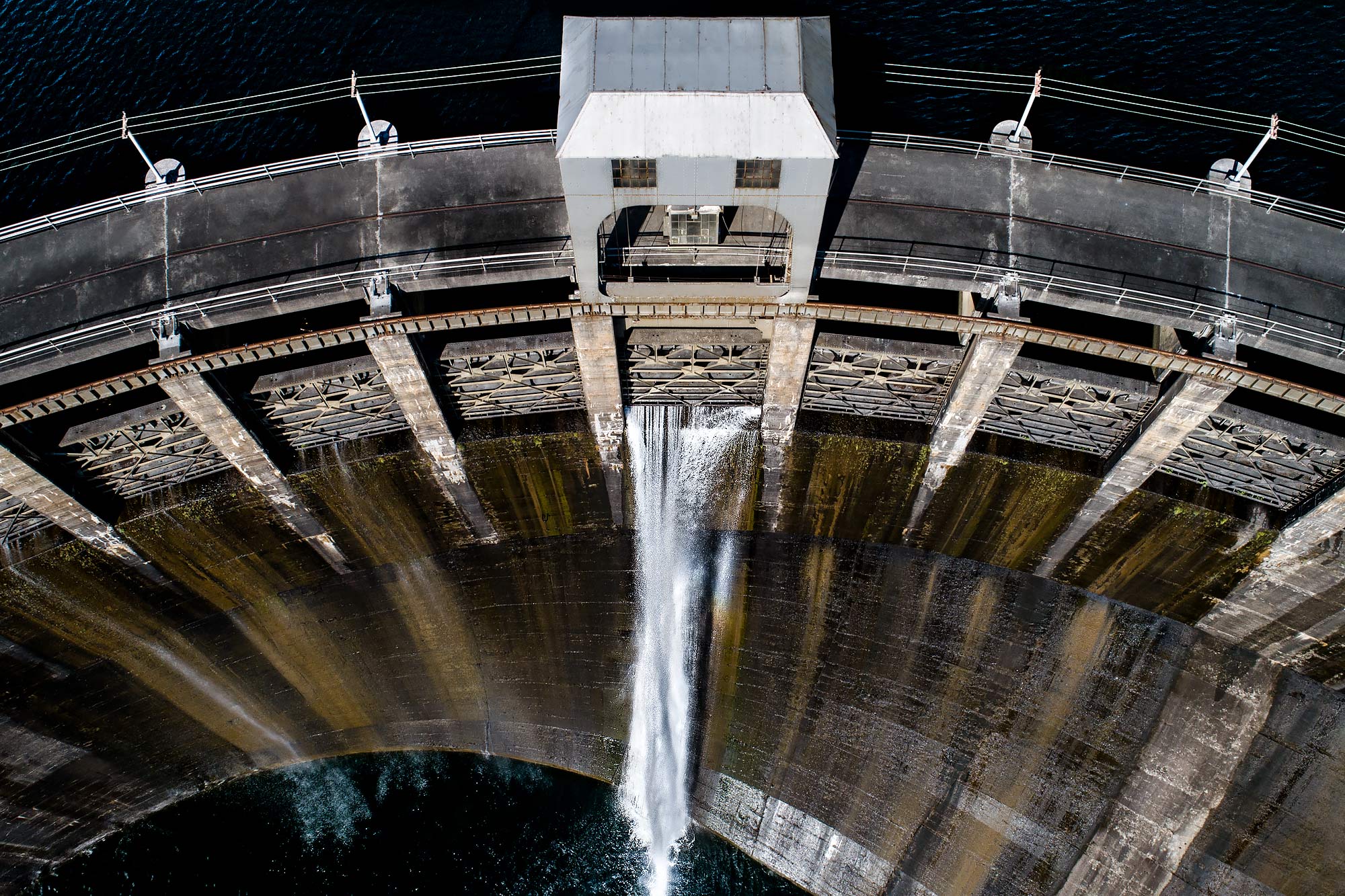 A close aerial shot of a hydroelectric dam with overflow gate opening |  Scott Gable industrial photographer
