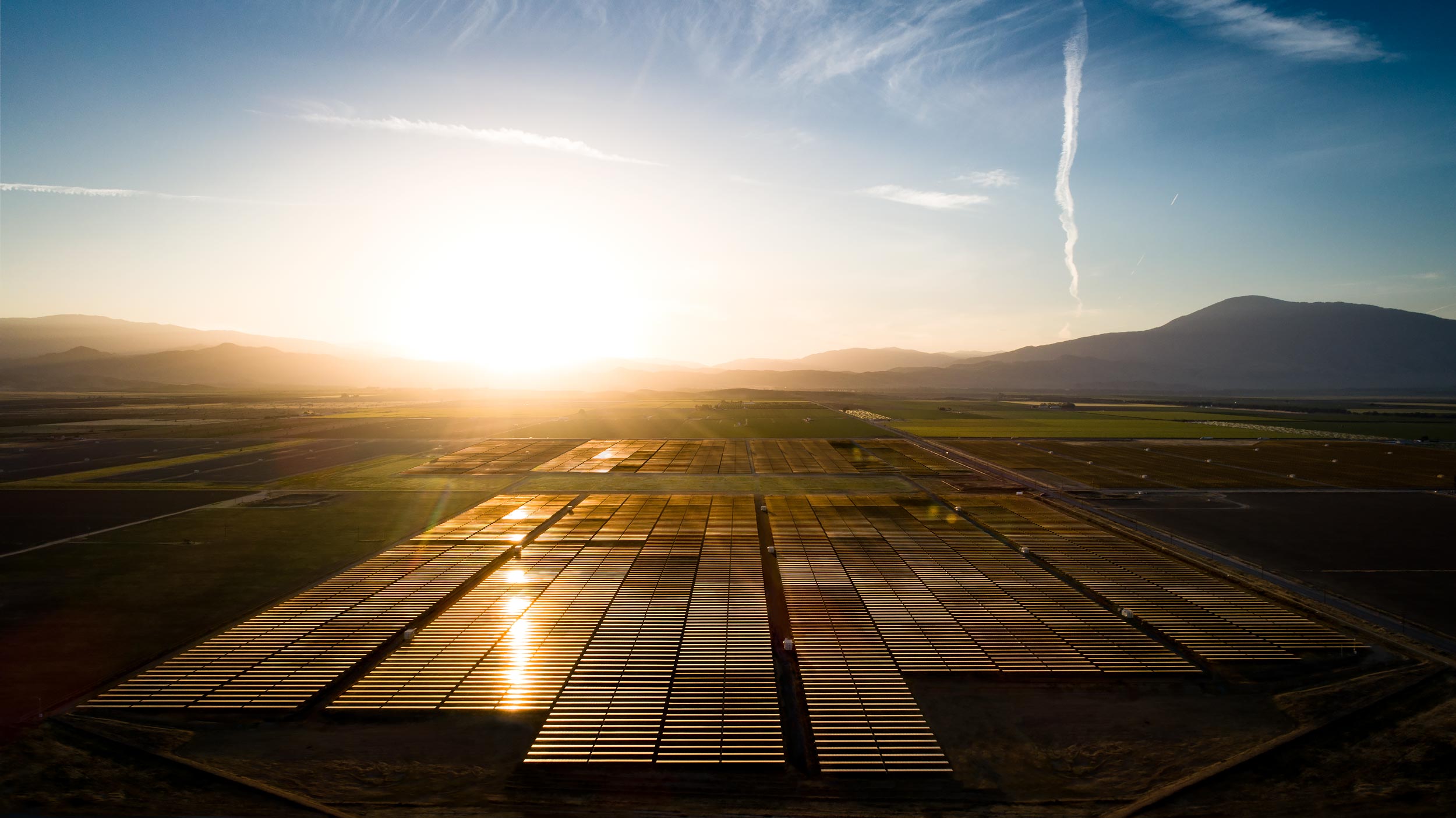 Aerial view of a solar array and surrounding fields at sunrise | Scott Gable industrial photographer