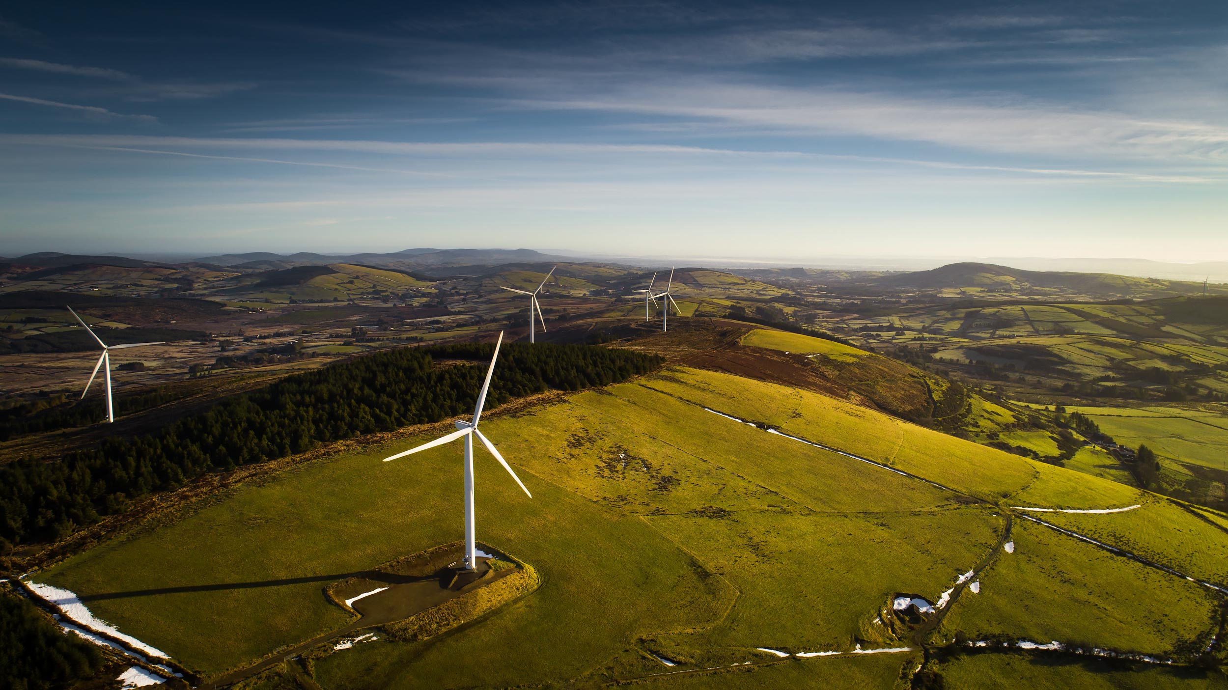 Aerial view of wind turbines on rolling green hills | Scott Gable industrial photographer