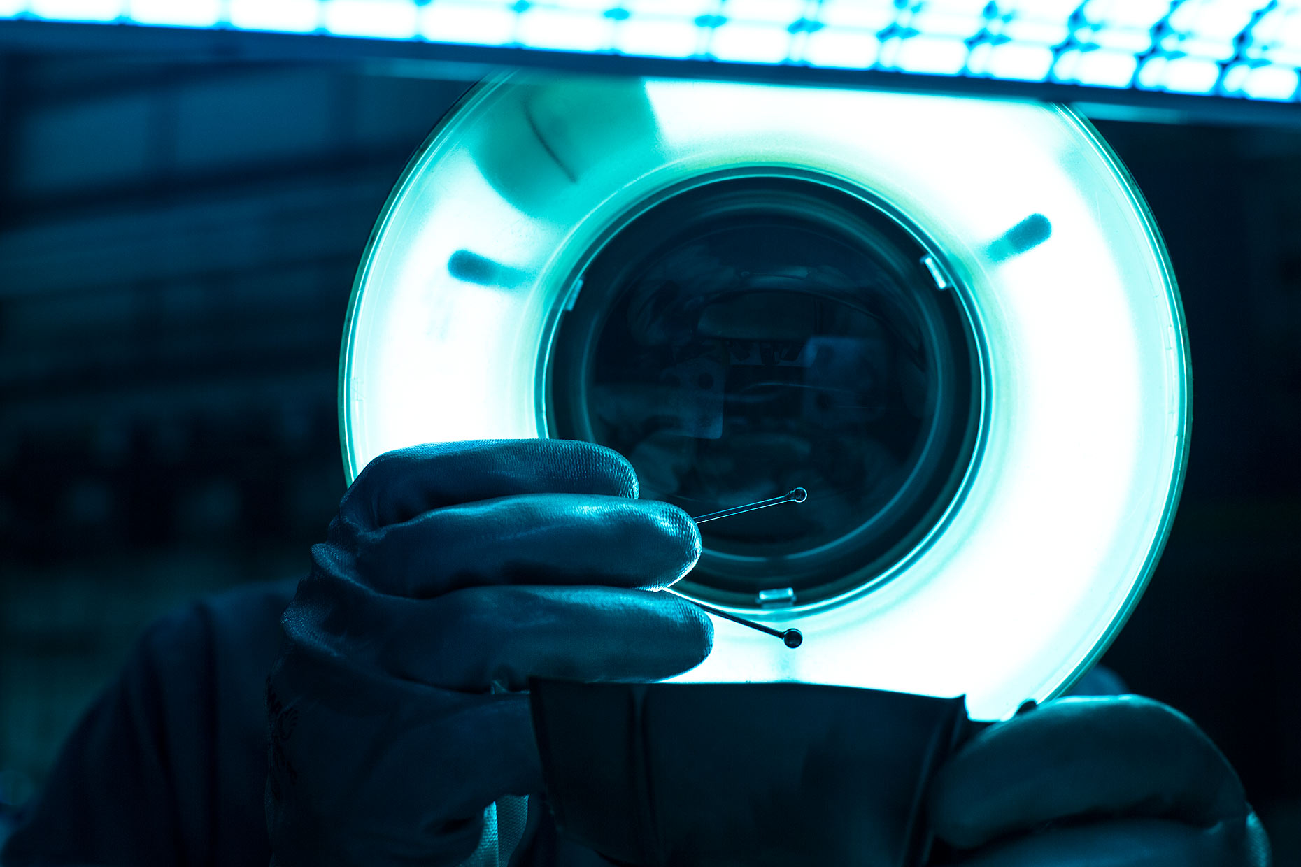 A technician inspects an instrument under LED magnifier | Scott Gable industrial photographer